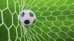 soccer ball in goal with green background